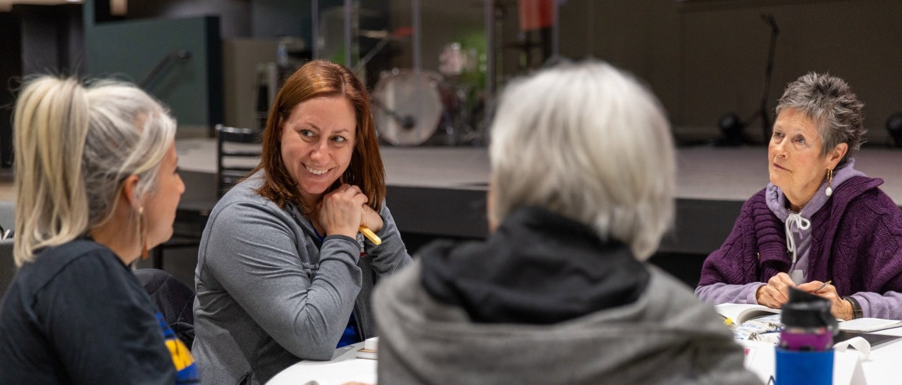 People in a classroom taking notes and learning